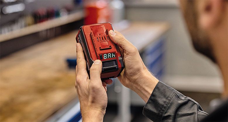 A man holding a Power-X-Change battery.