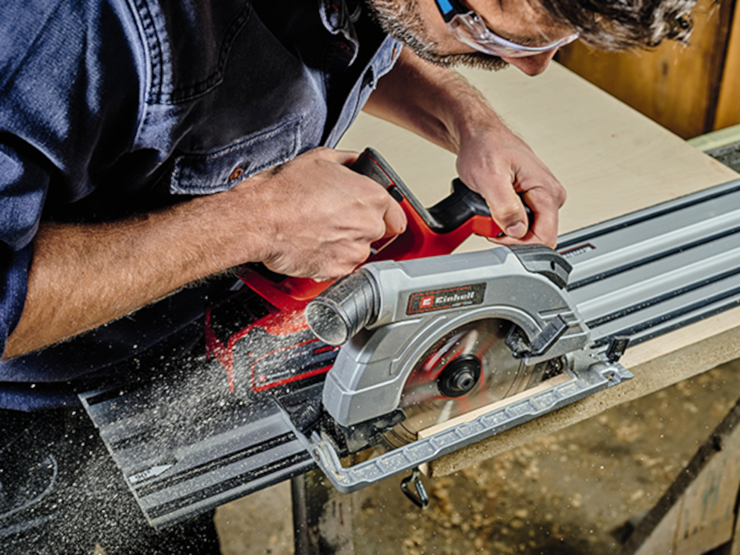 A man cuts a board with a cordless circular saw